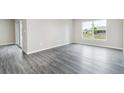 Bright and spacious living area with gray wood floors and sliding door to a patio at 3067 Newbury St, Port Charlotte, FL 33952