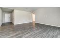 Spacious living room featuring gray wood flooring and neutral walls at 3067 Newbury St, Port Charlotte, FL 33952