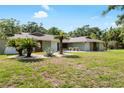 Beautiful single-story home featuring mature landscaping and lush lawn, providing great curb appeal in a quiet neighborhood at 4301 Hudson Ln, Tampa, FL 33618