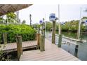 Waterfront property featuring a well-maintained dock with boat lift ready for nautical adventures at 5169 Oxford Dr, Sarasota, FL 34242
