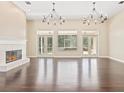 Bright living room with a cozy fireplace and elegant chandeliers at 11933 Pasco Trails Blvd, Spring Hill, FL 34610
