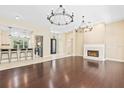 Open concept living space featuring dark wood floors and a fireplace at 11933 Pasco Trails Blvd, Spring Hill, FL 34610