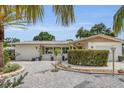 Well-maintained single-story house with stone landscaping and a vibrant front garden at 6012 1St W Ave, Bradenton, FL 34209