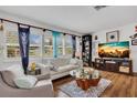 Inviting living room with wood floors, white sofa, and a decorative glass coffee table at 6012 1St W Ave, Bradenton, FL 34209