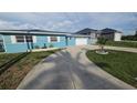 Lovely one-story home with well-maintained lawn, a large concrete driveway, and a two-car garage at 3510 Magnolia Way, Punta Gorda, FL 33950