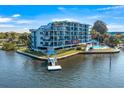 Exterior view of a waterfront condo building at 4823 Ebbtide Ln # 104, Port Richey, FL 34668