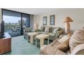 Living room with sofa and water views at 4823 Ebbtide Ln # 104, Port Richey, FL 34668