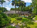 A lush backyard featuring a screened-in pool and verdant landscaping, creating a private outdoor oasis at 6049 Patricia Pl, Weeki Wachee, FL 34607