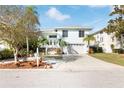 Two-story house with attached garage and landscaped yard at 6225 Bayside Dr, New Port Richey, FL 34652