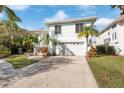 Two-story house with attached garage and landscaped yard at 6225 Bayside Dr, New Port Richey, FL 34652