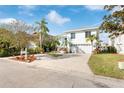 Two-story house with attached garage and landscaped yard at 6225 Bayside Dr, New Port Richey, FL 34652