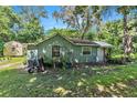 Rear view of the cottage showing additional outdoor space and AC unit at 1026 Roosevelt Ave, Spring Hill, FL 34604