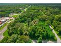 Aerial view showing the property's wooded surroundings and access roads at 1026 Roosevelt Ave, Spring Hill, FL 34604