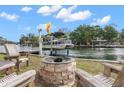 Brick fire pit with wooden chairs overlooking the water at 8064 Marys Fish Camp Rd, Weeki Wachee, FL 34607