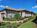 Single-story home with gray siding, tile roof, and landscaped yard at 3270 Francoa Dr, Odessa, FL 33556