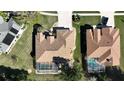 Two homes with pools and screened enclosures, viewed from above at 3473 Conifer Loop, Spring Hill, FL 34609