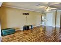 Living room with hardwood floors and a green ottoman at 1873 Mazo Mnr # T5, Lutz, FL 33558