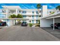 Modern condo building includes covered parking with lush landscaping and nearby walkways at 770 Island Way # N302, Clearwater, FL 33767