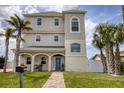 Charming three-story home featuring a welcoming entrance and beautiful landscaping at 13753 Judy Ave, Hudson, FL 34667