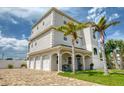 Three-story home with three-car garage and palm trees at 13753 Judy Ave, Hudson, FL 34667