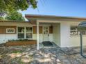 Mid-century home's front entrance with brick details at 4252 Courier Ln, Holiday, FL 34691