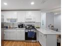 Modern white kitchen with stainless steel appliances and granite countertops at 5603 80Th N St # 207, St Petersburg, FL 33709