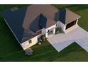 Single-story home with dark roof, driveway, and landscaping at 4101 Valley Brook Ct, Spring Hill, FL 34606
