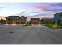 Two houses at dusk with three-car garages at 3154 Brigantine Ct, New Port Richey, FL 34652