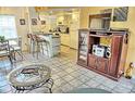 Kitchen with breakfast bar and view into the living and dining areas at 2077 Wetland Pt # 1202, Lutz, FL 33558