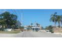 Gated community entrance with guard house and American flag at 8210 Aquila St # 226, Port Richey, FL 34668