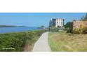 Scenic walkway along the waterfront with lush landscaping and condo building views at 8210 Aquila St # 226, Port Richey, FL 34668