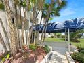 Condo entrance with lush landscaping and a covered walkway at 5537 Sea Forest Dr # 307, New Port Richey, FL 34652
