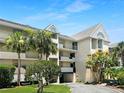 Condo building exterior showcasing landscaping and parking at 5537 Sea Forest Dr # 307, New Port Richey, FL 34652