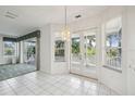 Dining area with tile floors, sliders to balcony, and chandelier at 329 Sunset Way, Palm Harbor, FL 34683