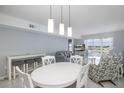 Bright dining area with white table and chairs at 4939 Floramar Ter # 610, New Port Richey, FL 34652