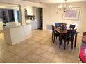 Open dining room featuring a chandelier and easy access to the kitchen at 5144 Chime Way, Holiday, FL 34690