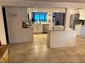 Bright kitchen with white cabinets, an island, and stainless steel appliances at 5144 Chime Way, Holiday, FL 34690