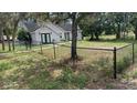 House with a chain link fence and large yard at 2013 Finland Dr, Spring Hill, FL 34609