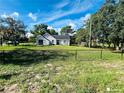 House with chain link fence and large yard at 2013 Finland Dr, Spring Hill, FL 34609