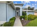 Front entrance with walkway, landscaping, and a covered porch at 11218 Sun Tree Rd, Hudson, FL 34667