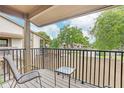 Private balcony with seating area and view of trees at 13002 Wedgewood Way # D, Hudson, FL 34667