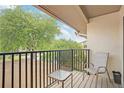 Private balcony with seating and view of parking at 13002 Wedgewood Way # D, Hudson, FL 34667