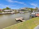 View of the canal with boats and neighboring houses at 7332 Islander Ln, Hudson, FL 34667