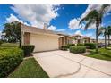 Brick house with a two-car garage, well-manicured landscaping and a palm tree at 1136 Flora Vista St, Trinity, FL 34655