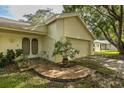 Home exterior featuring a stone walkway and garage at 12709 Clock Tower Pkwy, Hudson, FL 34667