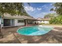 Relaxing kidney shaped pool in the backyard at 12709 Clock Tower Pkwy, Hudson, FL 34667