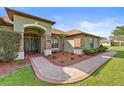 Front entry with paved walkway at 5007 Plumosa St, Spring Hill, FL 34607