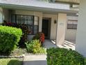 Front entry of a villa with landscaping and a paved walkway at 3275 Lori Ln # 5, New Port Richey, FL 34655