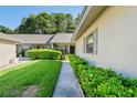 Side view of a villa with lush landscaping and walkway at 3275 Lori Ln # 5, New Port Richey, FL 34655