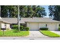 Front view of a charming villa with a well-maintained lawn and two-car garage at 3275 Lori Ln # 5, New Port Richey, FL 34655